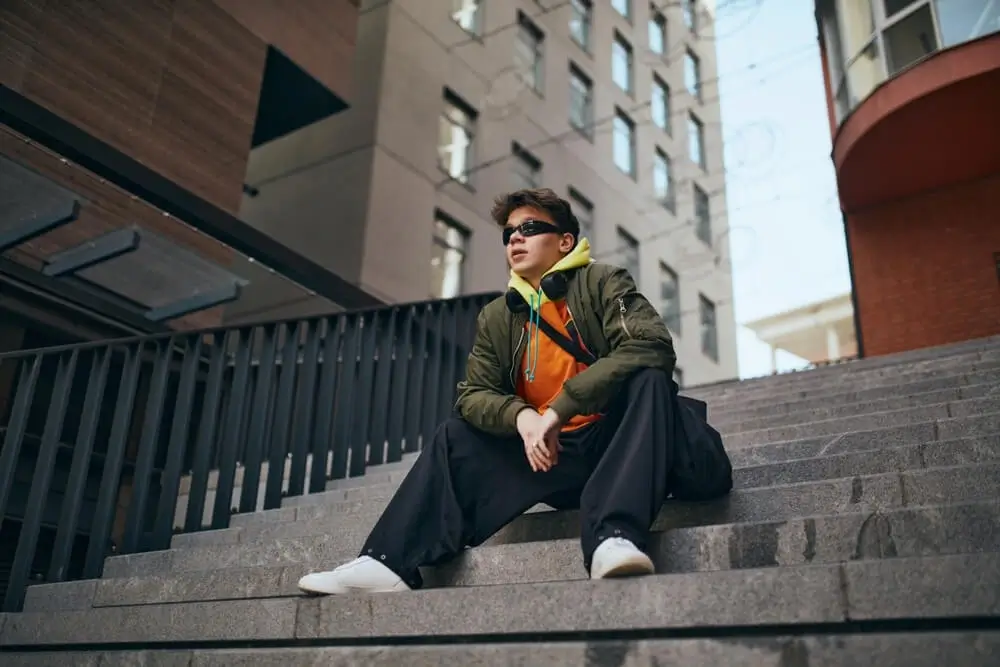 a boy showing his attitude by sitting on the stair showing Boys Attitude shayari - Theshayarihub